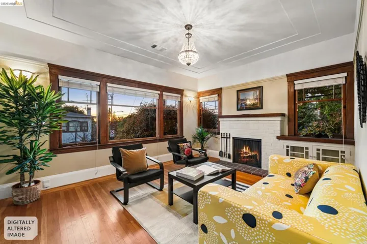 Living area featuring a fireplace, hardwood / wood-style floors, and a chandelier