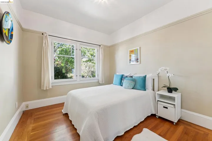 Bedroom featuring baseboards and wood finished floors