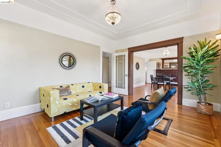 Living area with hardwood / wood-style flooring and suspended lighting