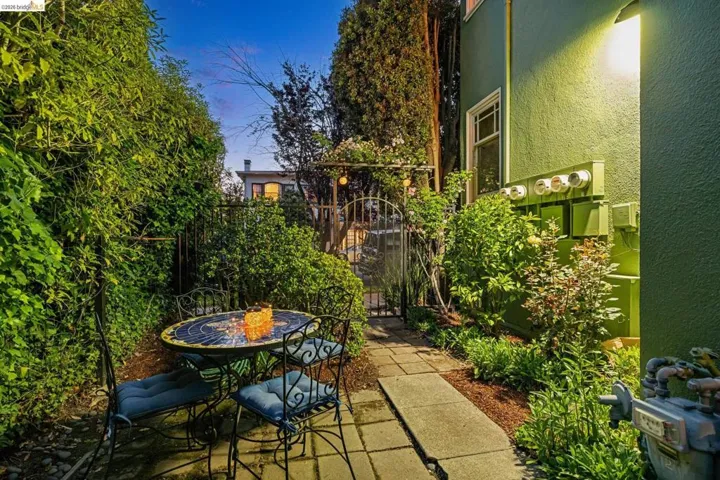 View of patio with a gate and outdoor dining space