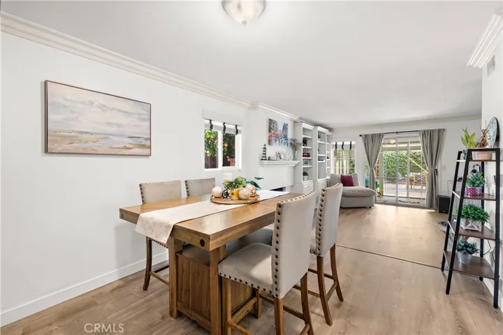 The home is beautifully appointed with wood laminate flooring, crown molding