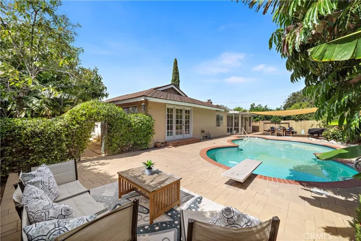the backyard feels like your own private resort with a sparkling pool