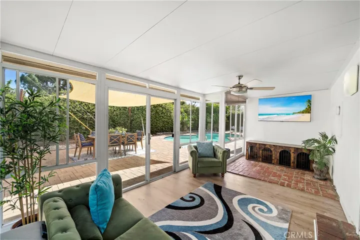 additional indoor-outdoor living space, complete with TV hookups and walls of windows overlooking the spectacular backyard oasis