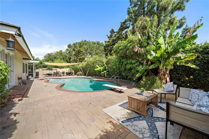pool surrounded by an expansive interlocking paver patio