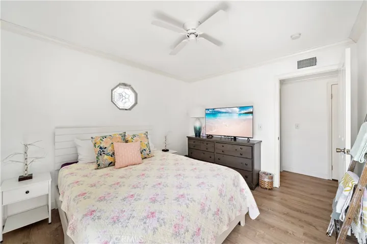 One of Three additional bedrooms are generously sized with ceiling fans and crown molding