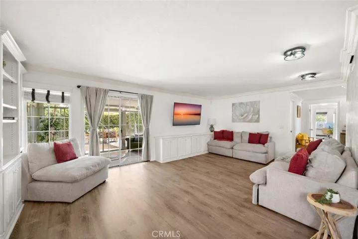 French-style sliders open from the living room to a versatile sunroom (California room)