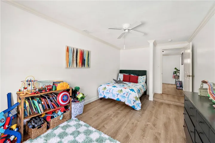 Three additional bedrooms are generously sized with ceiling fans, crown molding and wood laminate flooring