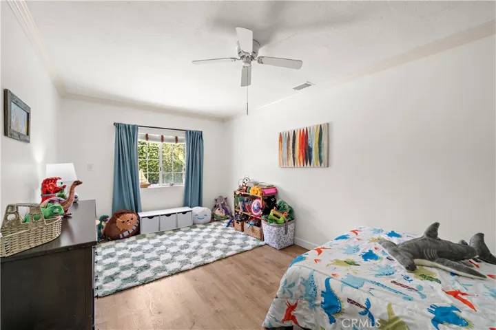 One of Three additional bedrooms are generously sized with ceiling fans