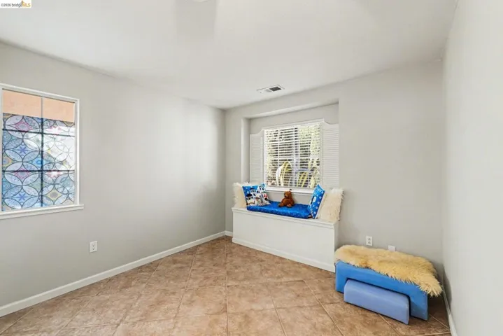 Sitting room featuring light tile patterned floors and baseboards