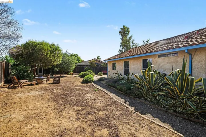 Fenced backyard with a patio area and a fire pit