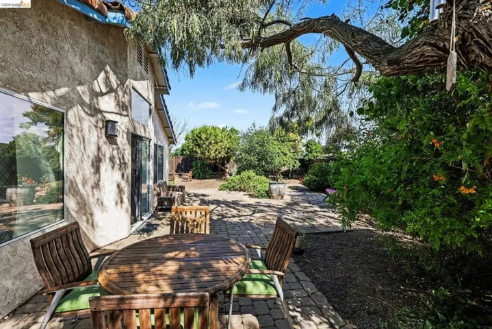 Fenced backyard with a patio area and outdoor dining area