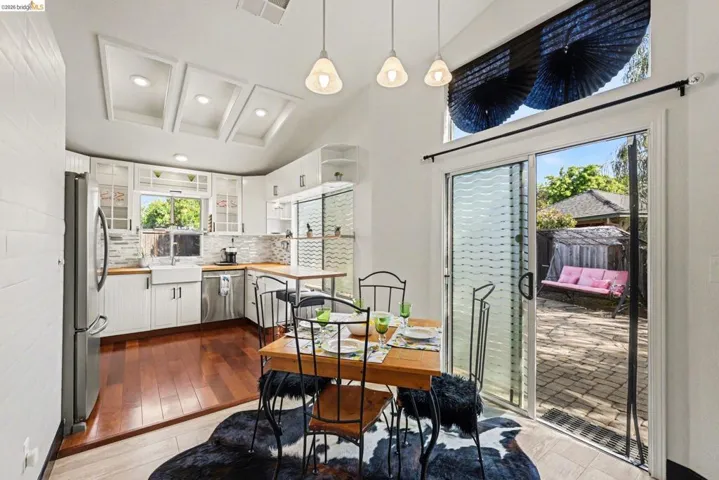 Dining space featuring dark wood-style flooring and recessed lighting
