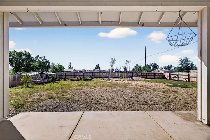 large back yard with garden beds and RV gates