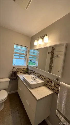 Modern bathroom has a window for plenty of air and natural light.