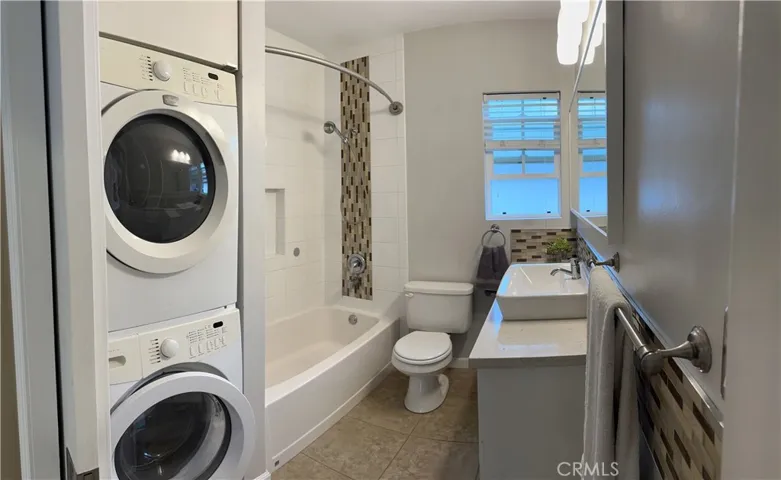 Full bathroom with washer and dryer