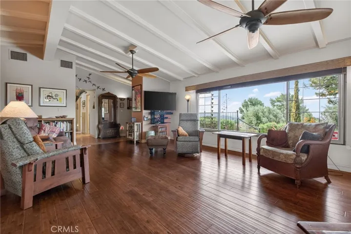 Two large ceiling fans help keep the room cool, while all the windows are double-paned, enhancing the energy efficiency of the entire home.