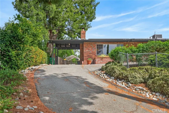 The front driveway brings you to the covered carport. There is also a 3 car detached garage in the back of the home.