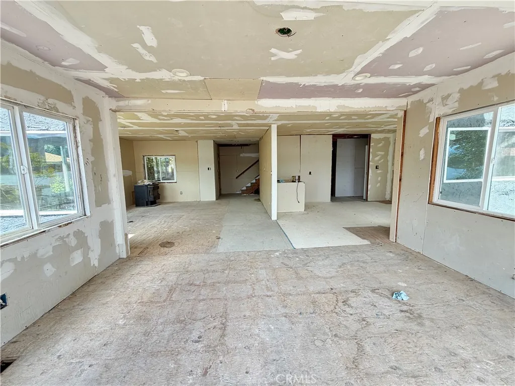 Unfinished Dining area in foreground, Kitchen area to the right and living room to the left Unfinished Dining area in foreground, Kitchen area to the right and living room to the left
