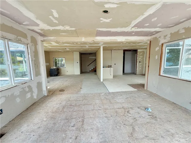 Unfinished Dining area in foreground, Kitchen area to the right and living room to the left