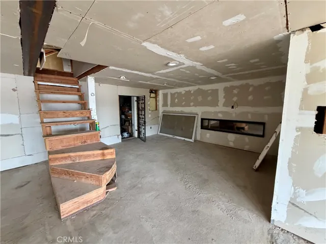 Bottom Level, unfinished, has electric fireplace for ambience.