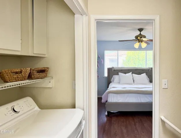 Laundry in hallway next to bedrooms