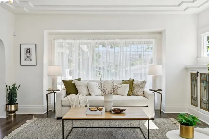 Living area with wood finished floors and arched walkways