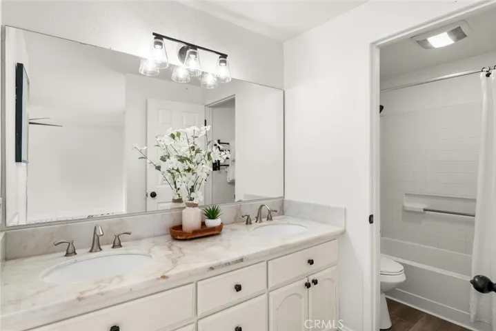 Dual vanity sink and tub shower combo in primary.