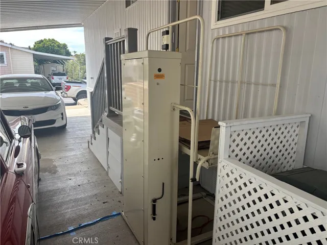 Electric person lift at driveway stairs.