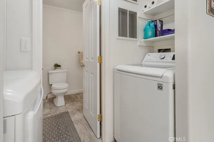 Washer and dryer in between kitchen and guest bathroom.