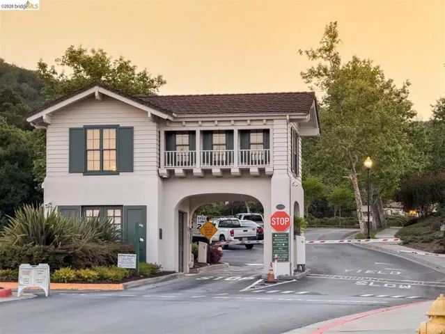 View of front of house featuring a balcony and stucco siding