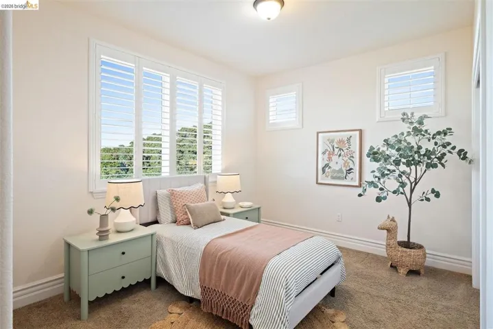 Bedroom featuring carpet floors and multiple windows