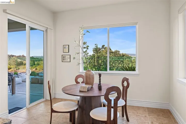 Dining area with light tile patterned flooring and healthy amount of natural light