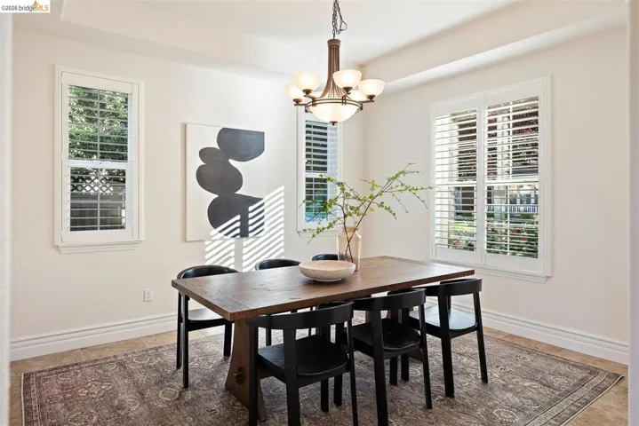 Dining area featuring a chandelier and baseboards