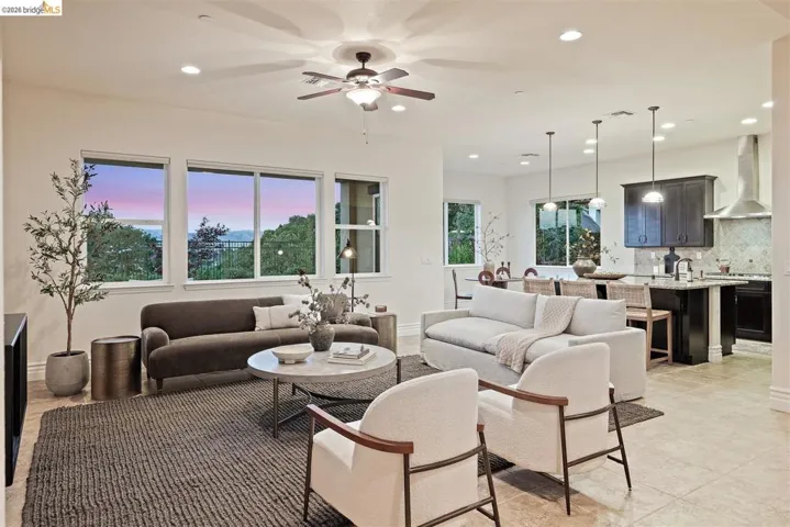 Living room featuring a ceiling fan and recessed lighting