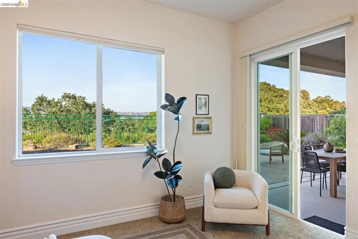 Living area featuring baseboards and carpet flooring