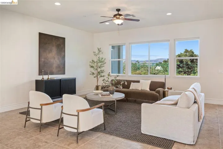 Living room with ceiling fan, recessed lighting, and a mountain view
