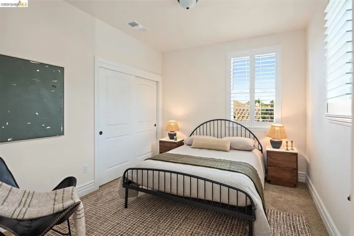 Bedroom featuring carpet flooring and a closet