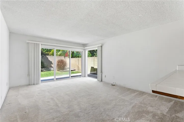 FAMILY ROOM WITH SLIDING DOOR TO THE BACKYARD