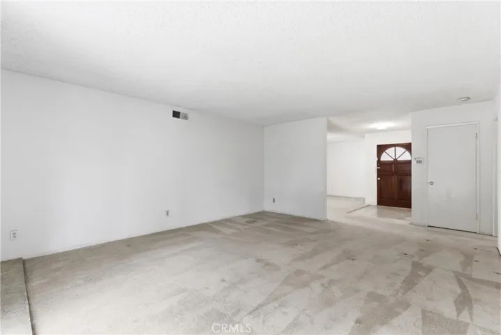 LIVING ROOM TOWARDS THE FRONT DOOR
