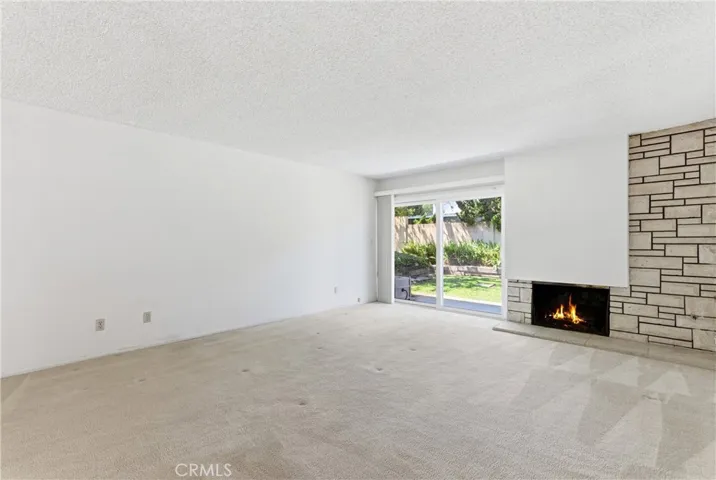 LIIVING ROOM WITH SLIDING DOOR ACCESS TO BACKYARD