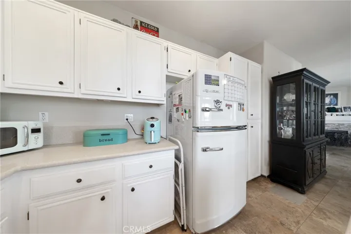 Kitchen With Generous Storage, White Cabinetry, And Functional Layout