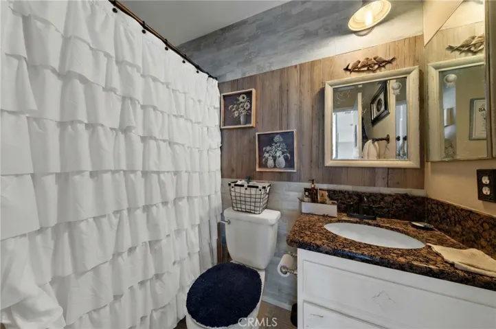 Bathroom Featuring Shower/Tub Combo, Extended Vanity, And Ample Counter Space