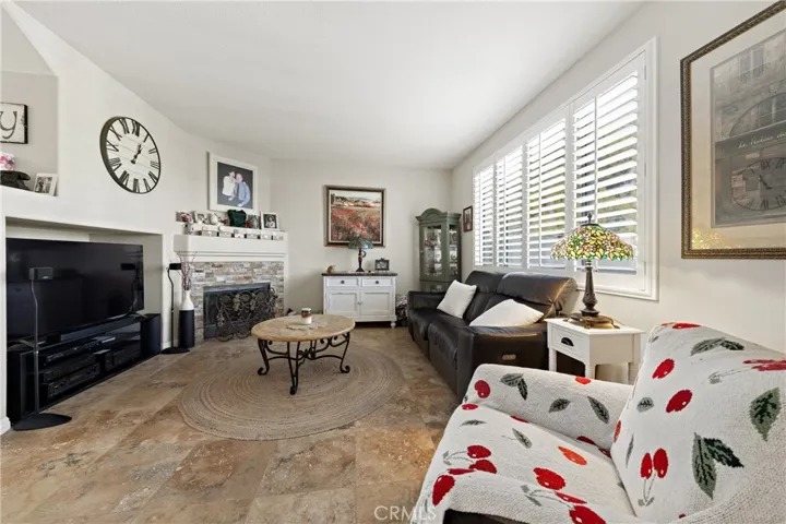 Cozy Family Room With Gas Fireplace And Large Windows. Custom Shutters