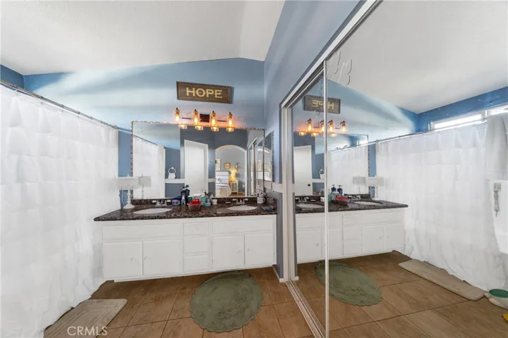 Dual Sink Vanity With Large Mirror And Ample Counter Space. Cool Tile. Tub/Shower Combo