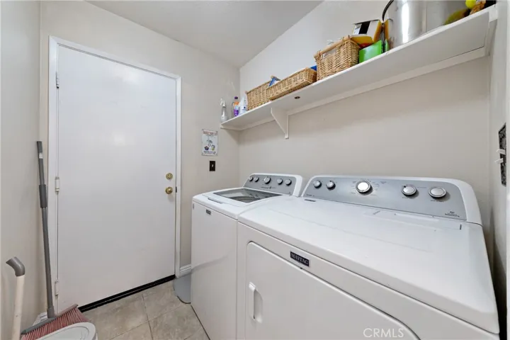 Indoor Laundry Room With Built-In Shelving And Storage. Washer and Dryer Will Remain "As Is"