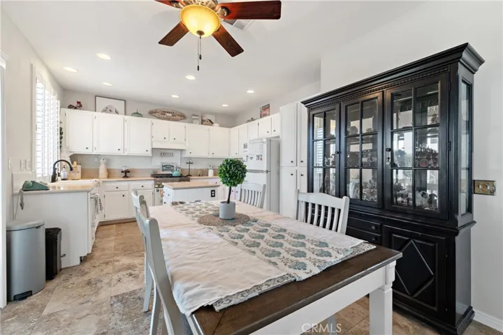 Well-Appointed Kitchen With Ample Cabinetry And Functional Layout. Cool Ceiling Fan