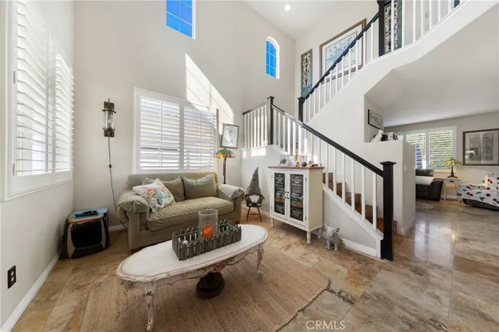 Light-Filled Living Room With Soaring Ceilings And Abundant Natural Light. Upscale Travertine Floors