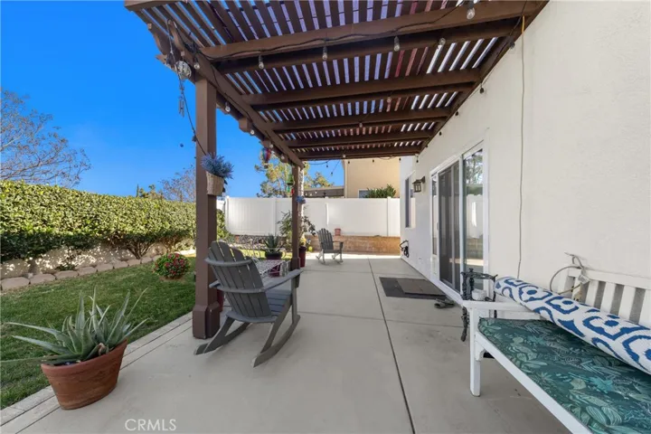 Covered Patio Perfect For Outdoor Dining And Relaxation. Vinyl and Block Wall Fencing