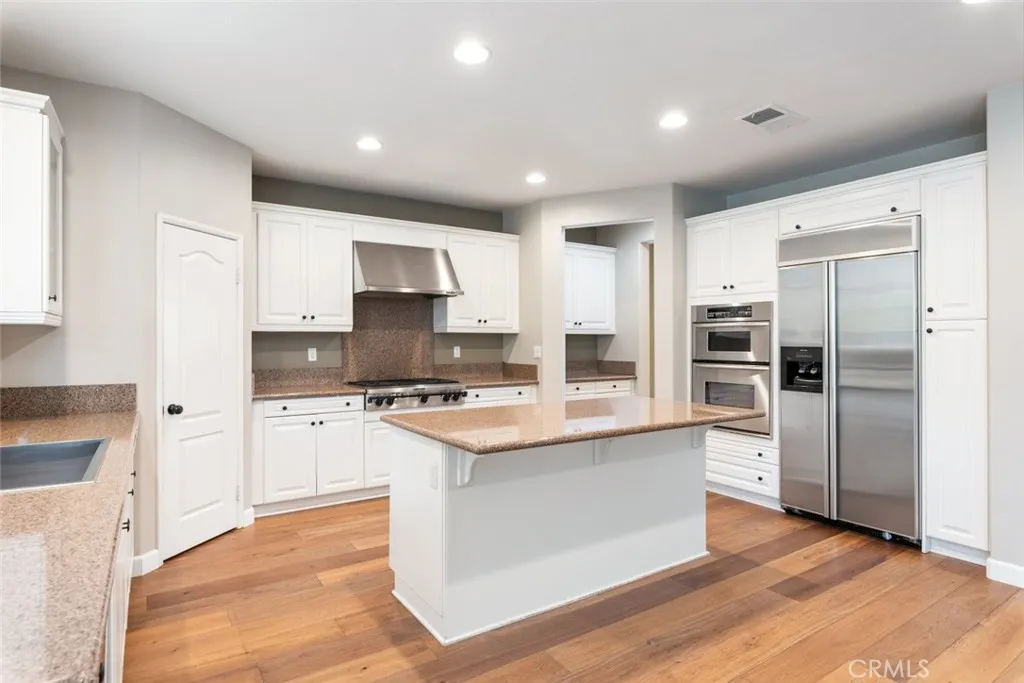 Kitchen w/pass-through butler's pantry, island w/breakfast bar, built-in fridge.
