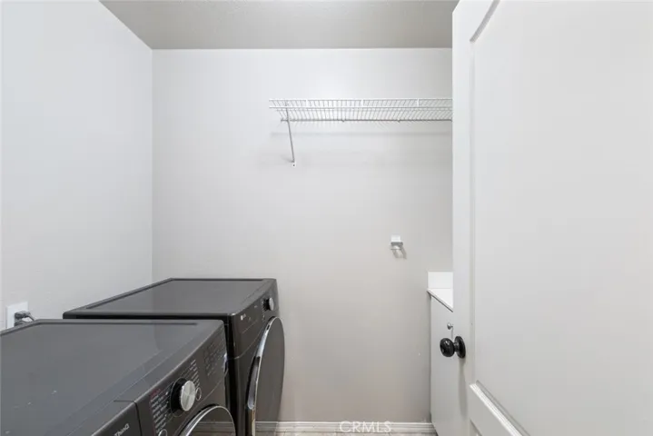 Inside laundry room w/utility sink and cabinets.